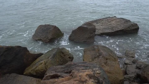 Scenic View of Ocean Waves Crashing Against Large Dark Coastal Rocks Stock Footage 340481295