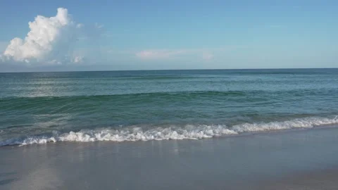 Scenic view of ocean waves rolling onto a white sand beach in Florida, sunny day Stock Footage 345676942