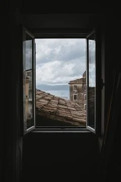 Scenic View from Open Window with Rooftops Stock Photos