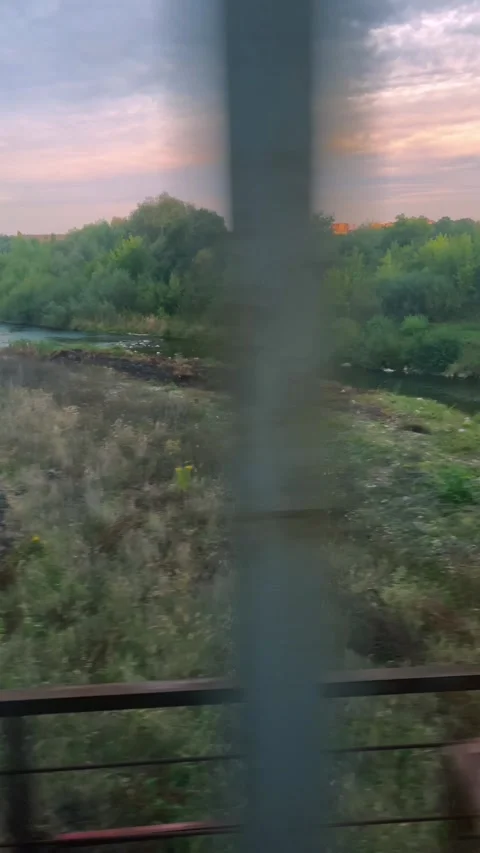 A scenic view opens from a train window as it crosses a railway bridge. 库存影片 346958704