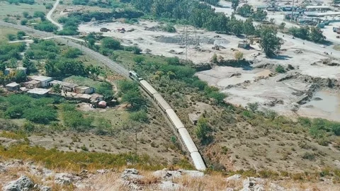 Scenic View of Passenger Train Emerging from Margalla Hills Tunnel Stock Footage 333542925