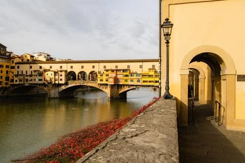 Scenic view of Ponte Vecchio bridge in Florence, Italy, from river walkway .. Stock Photos