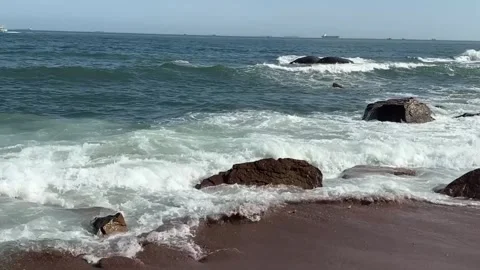 Scenic view of powerful sea waves breaking on rocky coastline with horizon ship Vídeos de archivo 334163557