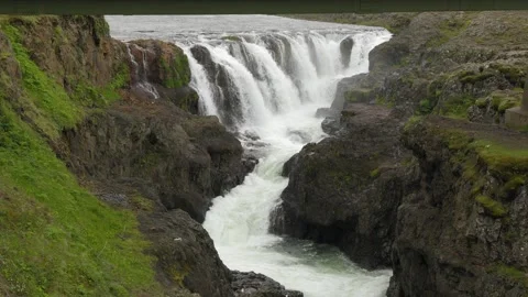 Scenic View of a Powerful Waterfall Flowing Through a Rocky Canyon in Iceland Video stock 339804607