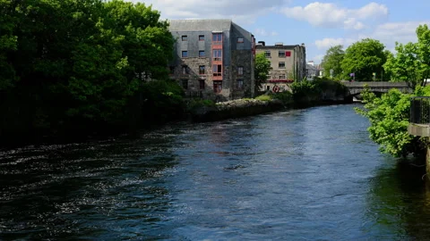 Scenic view, River Corrib flowing Galway, Ireland, historic stone buildings Stock Footage 339011666