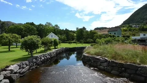 Scenic view of a river running through a village in Norway on a sunny day w.. Stock Footage 340204341