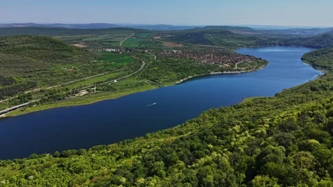 Scenic view of a river winding through green hills and small town Stock-Footage 338276208