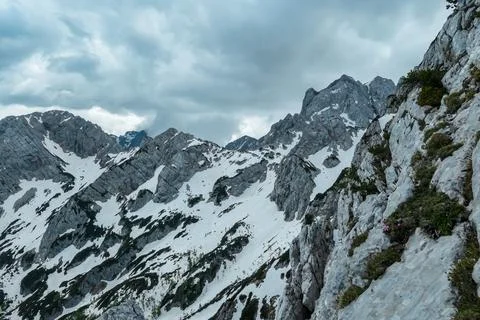 Scenic view on rocky sharp cloud covered summit of Jezerska Kocna in Kamnik.. Stock Photos