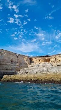 Scenic view of rugged limestone cliffs rising above the Atlantic Ocean with c Stock Photos