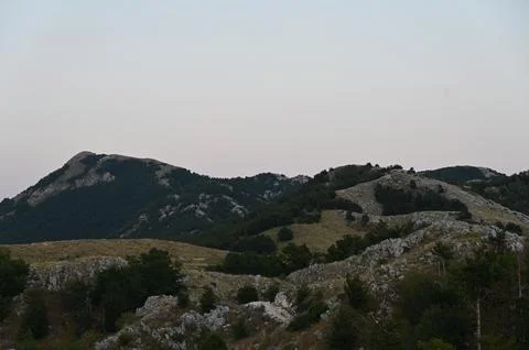 Scenic view of rugged mountain peaks and rocky hills at dusk Stock Photos