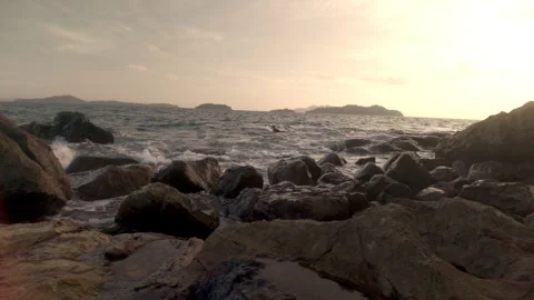 Scenic view of sea waves hitting rocky coastline under cloudy sky in the evening Vídeos de archivo 340253349