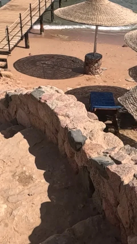 Scenic View of a Serene Beach Setting with Natural Stone Steps Leading Down to Stock Footage 330095657