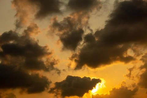 Scenic view of the sky with dark clouds during sunset in cityscape Stock Photos