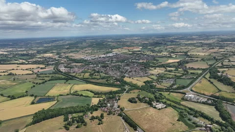 Scenic View of Small Town Surrounded by Lush Farmland and Trees 動画素材 312802859