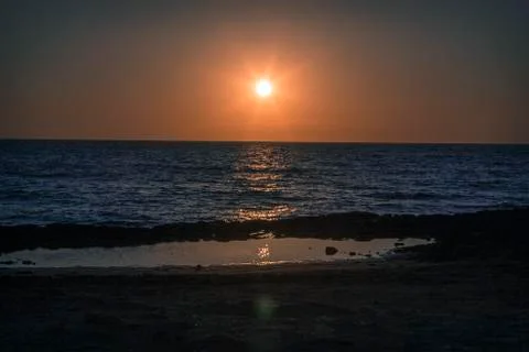Scenic view of sunset and reflection on water, greek Island, cyclades Stock Photos
