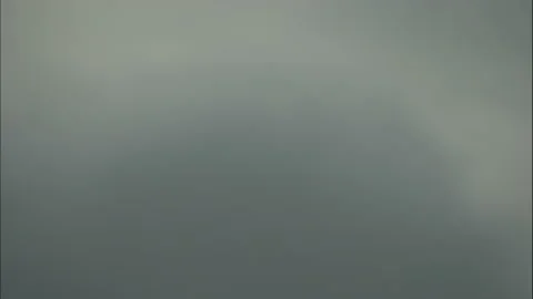 Scenic view of thick grey clouds rolling over sky carrying thunderstorm Stock Footage 208756122