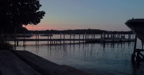 Scenic View of Tranquil Lake Overlooking the Sunset From a Dock Stock Footage 83470825