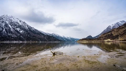 Scenic view of a tranquil mountain lake with snowcapped peaks Stock Footage 341938590