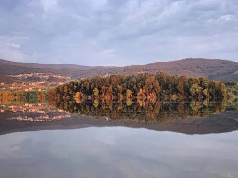 Scenic view of trees with fall colors reflected in lake Stock Photos