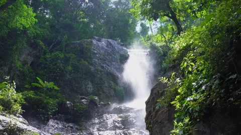 Scenic View of Tropical Waterfall Cascading Down Rocky Cliff Vidéo 344843096