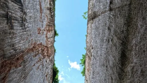 Scenic View of Two Tall Cliffs with Blue Sky and Trees on Bali Island Stock Footage 339947433