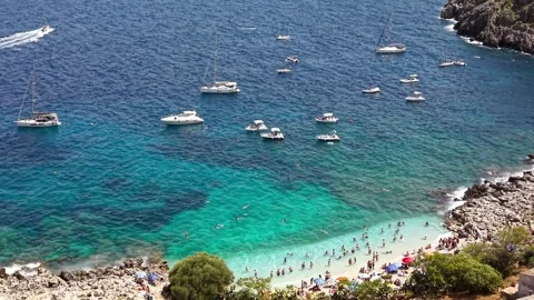 Scenic view of a vibrant beach with numerous people enjoying the sun Stock Footage 345155141