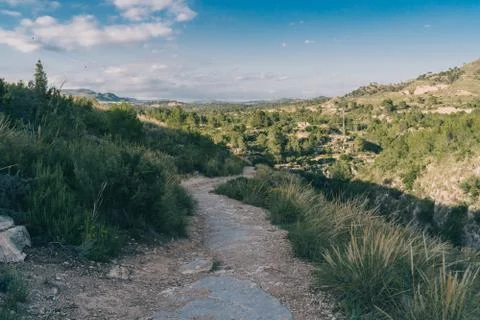 Scenic view. View of a stone path at Spanish hills,  dramatic clouds. Mediter Stock Photos