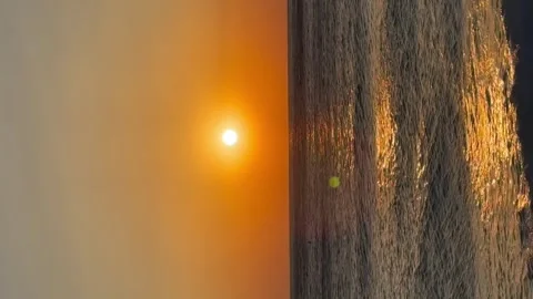 Scenic view of waves rushing at sandy beach against sky during sunset Stock Footage 273065020