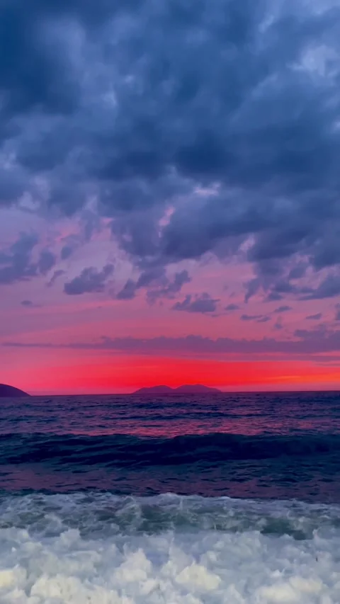 Scenic view of waves rushing at sandy beach against sky during sunset Stock Footage 284079136