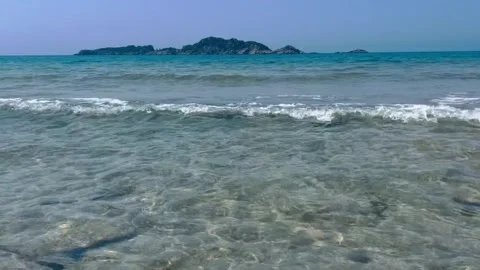 Scenic view of waves rushing at sandy beach against sky during sunset Stock Footage 284228406