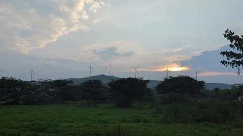 Scenic view of wind turbines under sunrise sky with soft light and open lan.. Vídeos de archivo 336042858