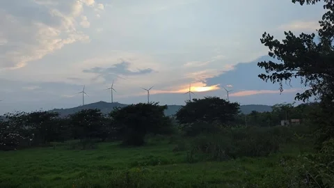 Scenic view of wind turbines under sunrise sky with soft light and open lan.. Stock Footage 336043503