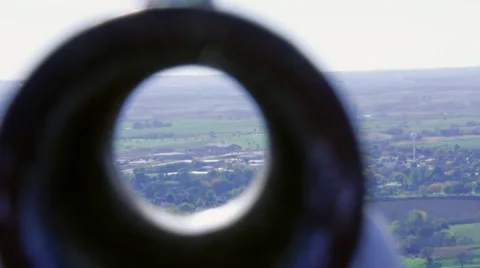 Scenic viewfinder, rack focus to distant town Stock Footage 31915508