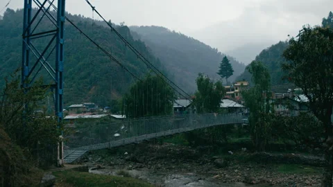 Scenic views of a bridge over a river near hills and a village Stock Footage 321376924