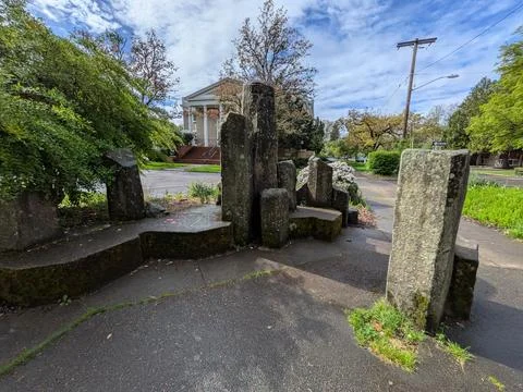 Scenic walking path framed by large brick pillars leading Stock Photos