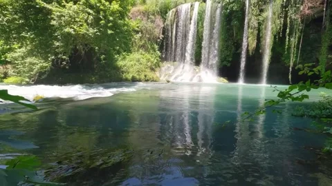 Scenic Waterfall Cascading with Forest Reflection Stock Footage 337699533