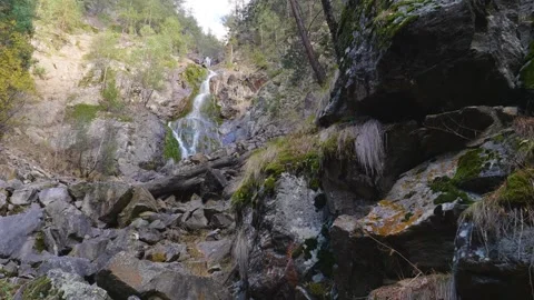 Scenic Waterfall in a Rocky Forest Landscape Stock Footage 320855344