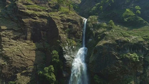 Scenic waterfall stream rushing down from edge of mountain cliff Stock Footage 124678989