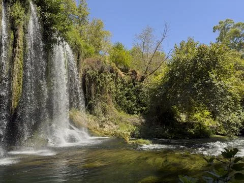 Scenic waterfall surrounded by trees Stock Photos