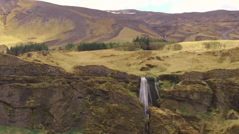 Scenic waterfall with winding ring road in the mountain background, Iceland Stock Footage 340179550