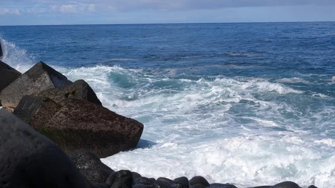 Scenic waves of Atlantic Ocean slow motion rushing to a black pebble shore Stock Footage 86208044