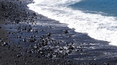 Scenic waves of Atlantic Ocean slow motion rushing to a black volcanic shore Stock Footage 86208433