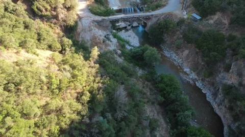 Scenic wide angle aerial view of a forest ravine with a small waterfall Stock Footage 343962690