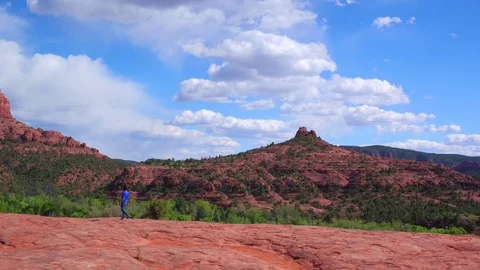 Scenic Wide Pullback Shot Man Walking On Rocks Sedona, Arizona Stock Footage 75726298