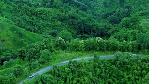 Scenic Winding Road Through Lush Green Hills 스톡 동영상 336418093