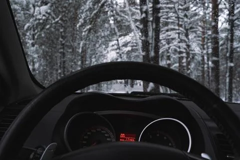 Scenic winter forest view through the windshield Stock Photos