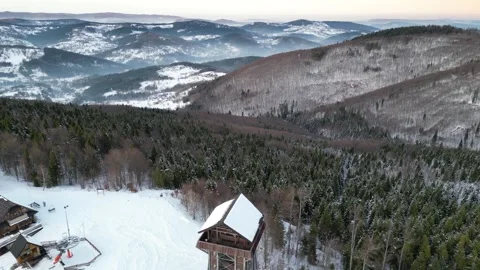 Scenic winter landscape featuring a distant observation tower amidst snow Видео 335887626