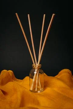 Scented diffuser sticks. empty glass bottle. yellow black backgorund Stock Photos