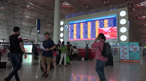 Schedule board and information booth at Beijing airport, China Stock Footage 60267685