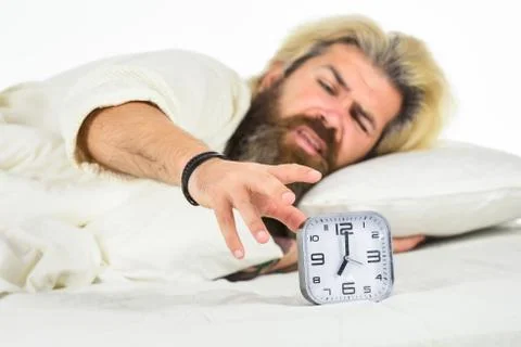 Schedule. Getting to bed on time. Get up right now. Stressed man alarm clock Foto stock
